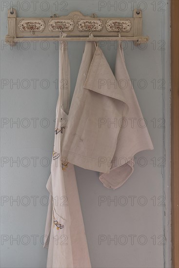 Decorative board with hooks for tea towels and aprons in a 19th century kitchen, Open-Air Museum of Folklore Schwerin-Muess, Mecklenburg-Western Pomerania, Germany, Europe