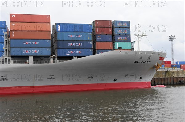 Bow of a large container ship WAN HAI 501 with red stripe and stacked containers, Hamburg, Hanseatic City of Hamburg, Germany, Europe