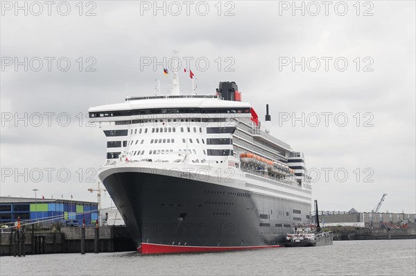 A large cruise ship QUEEN MARY 2, at a mooring in cloudy weather, Hamburg, Hanseatic City of Hamburg, Germany, Europe