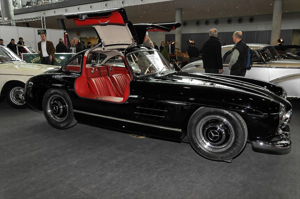 RETRO CLASSICS 2010, Stuttgart Messe, Stuttgart, Baden-Wuerttemberg, Germany, Europe, classic car, Mercedes-Benz 300 SL, Classic black car with open gullwing doors at a trade fair, Europe