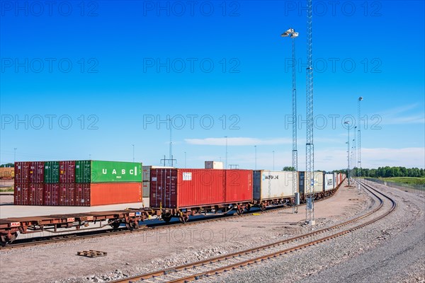 Railway wagons with containers on a loading area