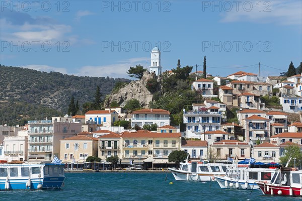 View of an idyllic Mediterranean coastal town with harbour, whitewashed houses and blue sky, view from Galatas, Argolis, to Poros, Poros Island, Saronic Islands, Peloponnese, Greece, Europe