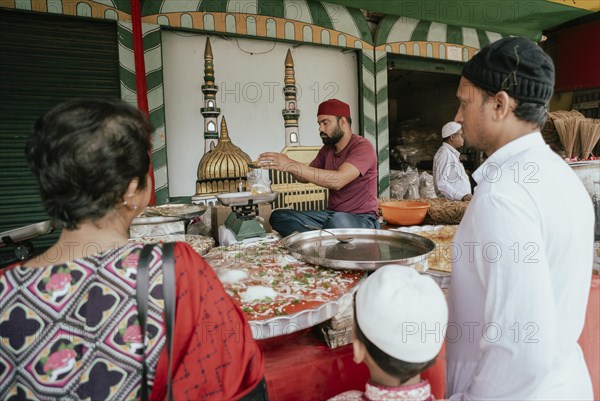 People buy food at a stall to break their fast during the holy month of Ramadan, on March 15, 2024 in Guwahati, Assam, India, Asia