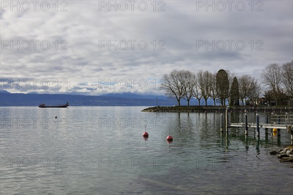 View of Lake Geneva with cargo ship from the Ouchy neighbourhood, Lausanne, Lausanne district, Vaud, Switzerland, Europe