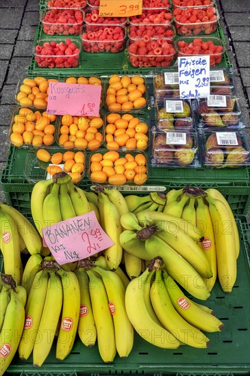 A fruit stand with figs, raspberries, kumquats (Fortunella), and bananas in mid-March, Kempten, Allgaeu, Bavaria, Germany, Europe