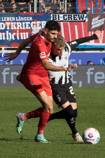 Football match, Eren DINKCI 1.FC Heidenheim left in a duel for the ball with Robin HACK Borussia Moenchengladbach, football stadium Voith-Arena, Heidenheim