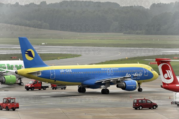 Blue and yellow Ukraine International aircraft on the tarmac, Hamburg, Hanseatic City of Hamburg, Germany, Europe