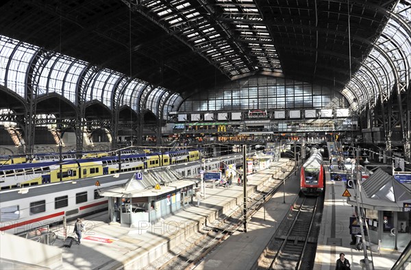 Spacious station concourse with trains, tracks and a few people, Hamburg, Hanseatic City of Hamburg, Germany, Europe