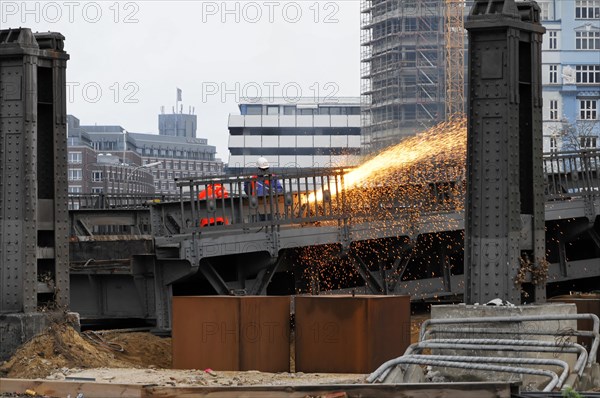 Worker on construction site during welding work with sparks flying in the twilight, Hamburg, Hanseatic City of Hamburg, Germany, Europe
