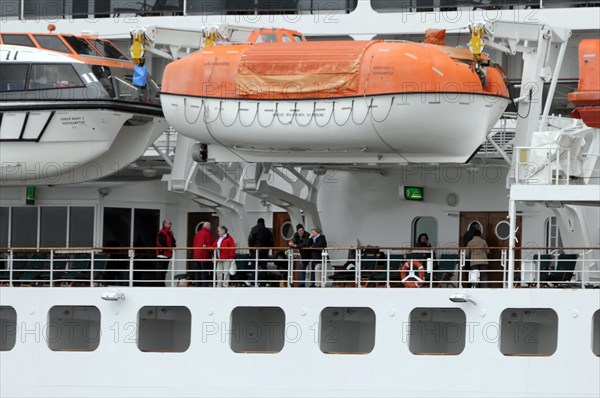 Passengers stand next to lifeboats on board the Queen Mary 2, Hamburg, Hanseatic City of Hamburg, Germany, Europe
