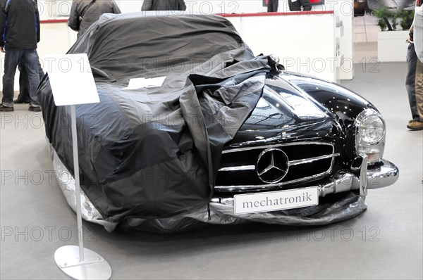 RETRO CLASSICS 2010, Stuttgart Messe, A Mercedes-Benz partially covered with a tarpaulin in a workshop environment, Stuttgart Messe, Stuttgart, Baden-Wuerttemberg, Germany, Europe