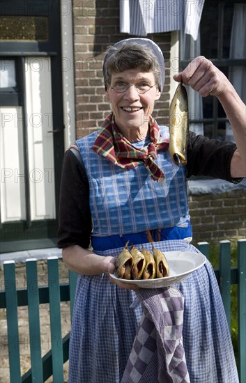 Woman holding fish, Urk village, Zuiderzee museum, Enkhuizen, Netherlands