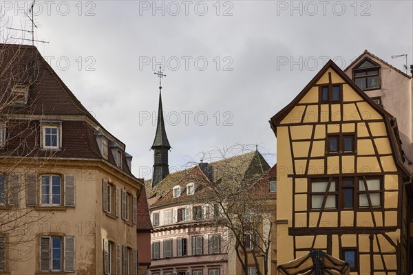Facades of historic houses with small tower and half-timbered house in the old town centre of Colmar, Department Haut-Rhin, Grand Est, France, Europe