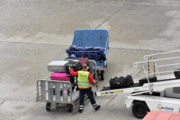 Airport employee operating a luggage trolley on the tarmac, Hamburg, Hanseatic City of Hamburg, Germany, Europe
