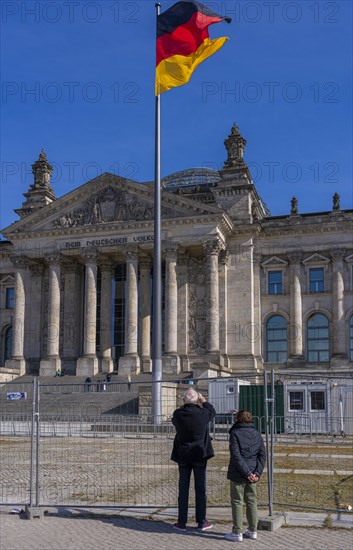 Tourists standing at the construction fence in front of the Reichstag building, Berlin, Germany, Europe