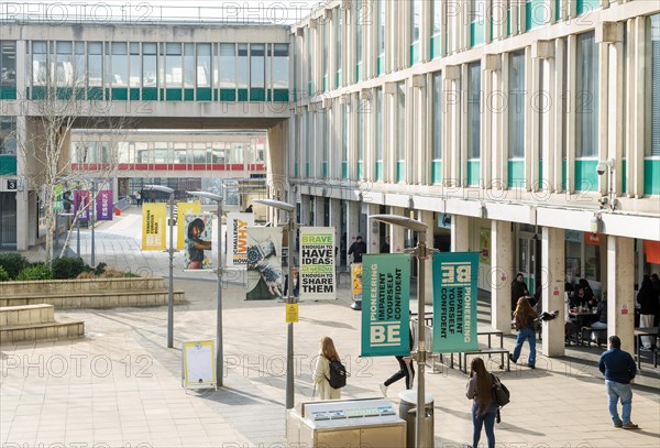 Students walking in campus square area, University of Essex, Colchester, Essex, England, UK