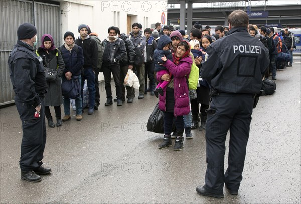 Refugees arriving at Rosenheim station, being taken to registration by federal police officers, 05/02/2016