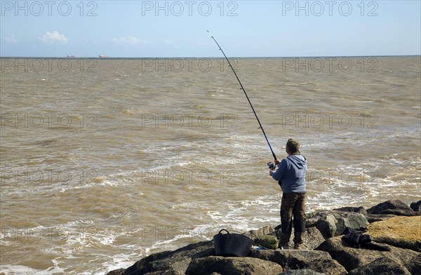 Man sea fishing East Lane, Bawdsey, Suffolk, England, United Kingdom, Europe