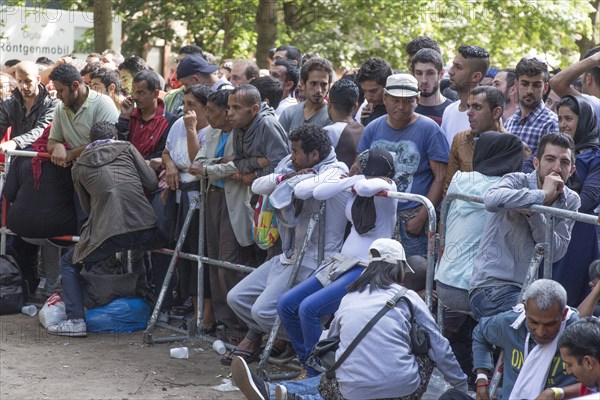 Refugees from Syria wait behind barriers in the central reception centre for asylum seekers at the State Office for Health and Social Affairs in Berlin, 26/08/2015