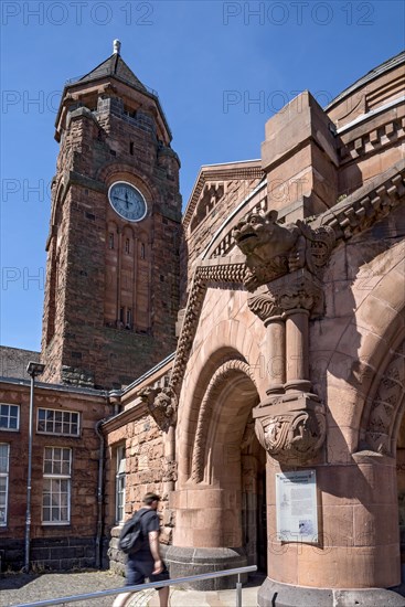 Historic Wilhelmine railway station, clock tower, pavilion with gargoyle, entrance to the station building, neo-Romanesque and Art Nouveau, red sandstone, cultural monument, listed building, Giessen, Giessen, Hesse, Germany, Europe