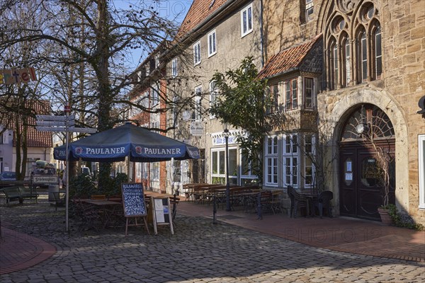 Restaurant with outdoor area, umbrella and benches in the Schnurrviertel in Minden, Muehlenkreis Minden-Luebbecke, North Rhine-Westphalia, Germany, Europe