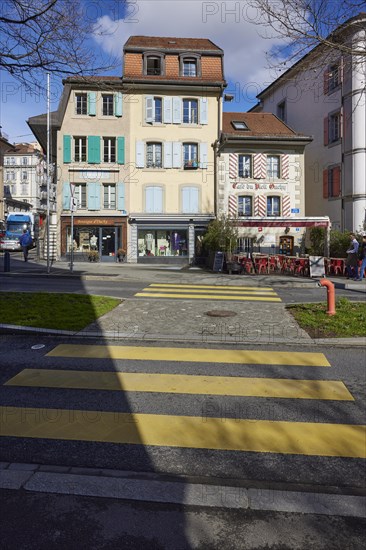 Old pastel-coloured houses with white windows and wooden shutters and the Cafe Vieil Ouchy on a zebra crossing in the Ouchy district, Lausanne, district of Lausanne, Vaud, Switzerland, Europe
