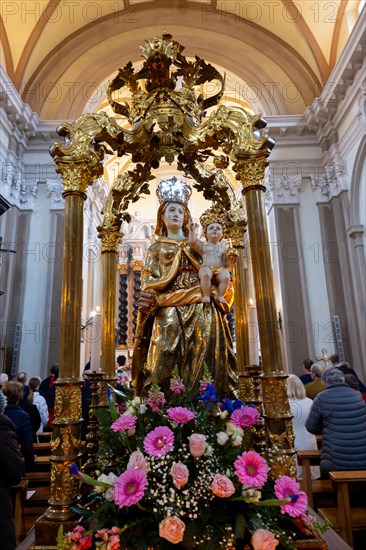 Madonna Santa Maria Statue and People Praying Inside the Church of San Nazzaro (Croglio) in Castelrotto, Ticino, Switzerland, Europe