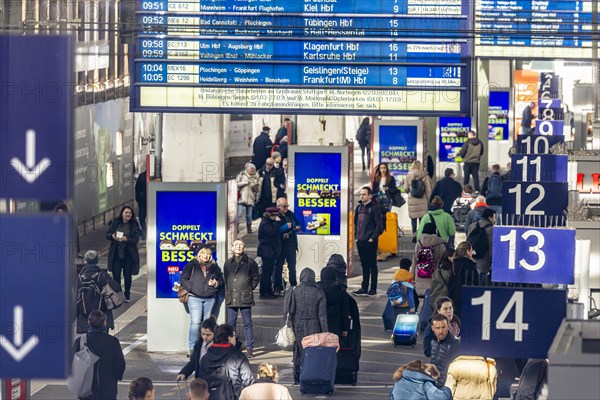 Central station, travellers in the platform hall. Extensive construction work on the railway network is communicated on the display board, Stuttgart, Baden-Wuerttemberg, Germany, Europe