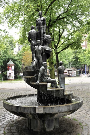 Sculpture fountain with human figures in the park, Hamburg, Hanseatic City of Hamburg, Germany, Europe