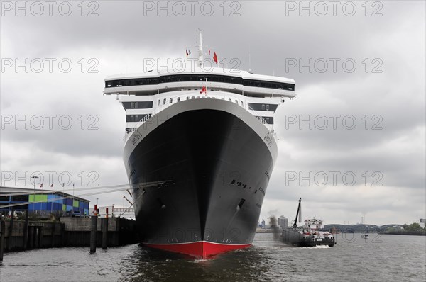 A large cruise ship is moored in the harbour against a cloudy sky, Hamburg, Hanseatic City of Hamburg, Germany, Europe