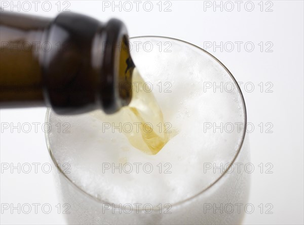 Beer is poured from a beer bottle into a beer glass, 07.12.2016