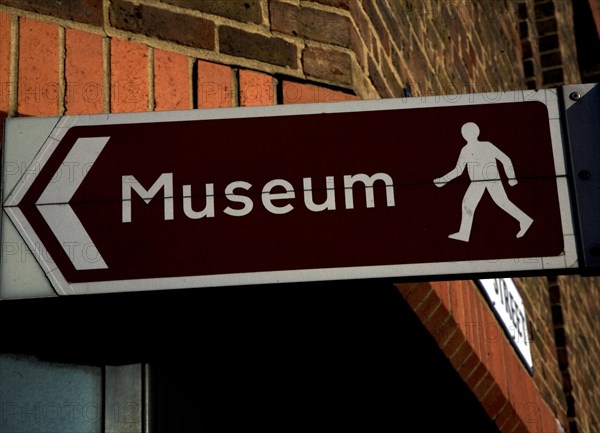 Museum sign pointing direction by foot, England, UK