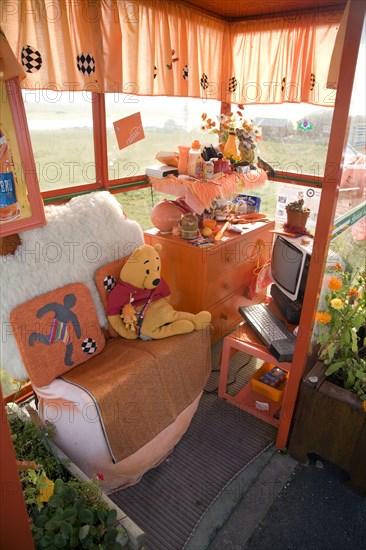 Orange colour theme decorated bus shelter, Haroldswick, Unst, Shetland Islands, Scotland, United Kingdom, Europe