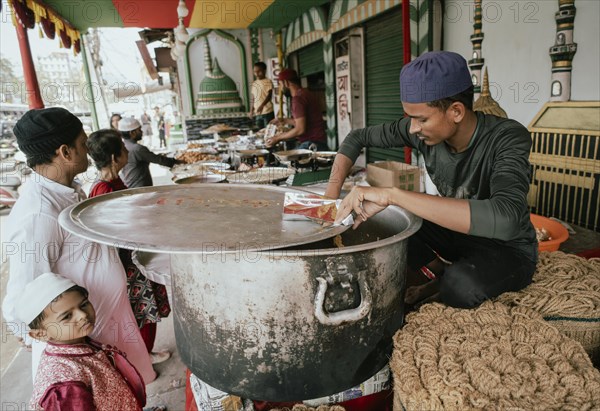 People buy food at a stall to break their fast during the holy month of Ramadan, on March 15, 2024 in Guwahati, Assam, India, Asia