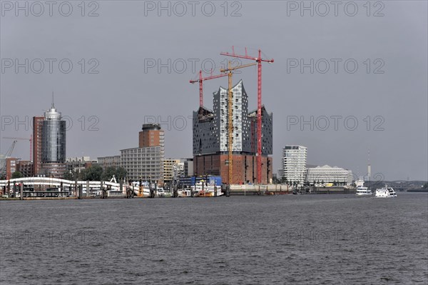 View of the Elbe Philharmonic Hall in Hamburg with construction cranes in cloudy weather, Hamburg, Hanseatic City of Hamburg, Germany, Europe