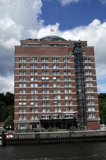 Modern hotel building on a riverside with blue sky and clouds, Hamburg, Hanseatic City of Hamburg, Germany, Europe