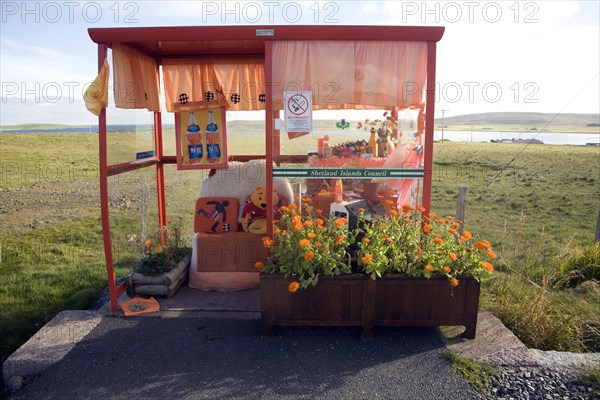 Orange colour theme decorated bus shelter, Haroldswick, Unst, Shetland Islands, Scotland, United Kingdom, Europe