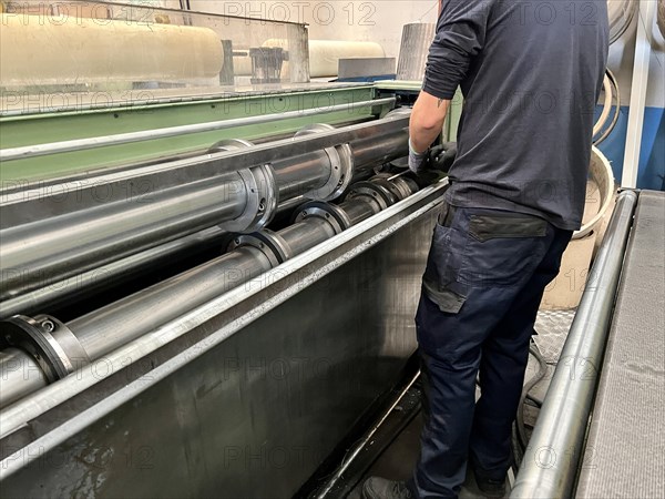 Portrait of a man placing the blades for cutting sheet metal on a metal cutting machine. metalworking industry