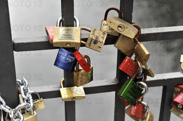 Love locks of young lovers at the Niederbaumbruecke, Speicherstadt, Hamburg harbour, Colourful love locks attached to a metal fence, Hamburg, Hanseatic City of Hamburg, Germany, Europe
