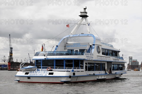 An excursion boat with a blue hull and white superstructure sails through Hamburg harbour, Hamburg, Hanseatic City of Hamburg, Germany, Europe
