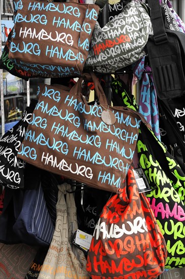 Colourful souvenir bags with the imprint 'Hamburg' stacked for sale, Hamburg, Hanseatic City of Hamburg, Germany, Europe