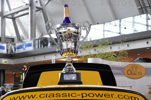 RETRO CLASSICS 2010, Stuttgart Trade Fair Centre, Shiny winner's trophy on a yellow sports car at a trade fair, Stuttgart Trade Fair Centre, Stuttgart, Baden-Wuerttemberg, Germany, Europe