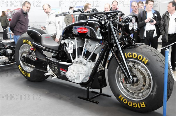 RETRO CLASSICS 2010, Stuttgart Messe, A black motorbike with RIGDON tyres is viewed by people at a trade fair, Stuttgart Messe, Stuttgart, Baden-Wuerttemberg, Germany, Europe