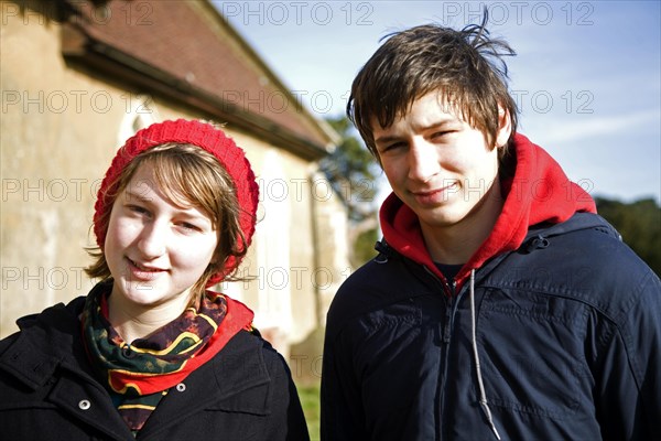 Model released head and shoulders portrait of boy and girl twins standing together in winter, Suffolk, England, United Kingdom, Europe