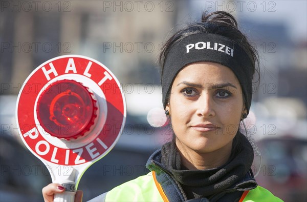 Policewoman of the Berlin police with police trowel during a traffic control, 20/03/2015