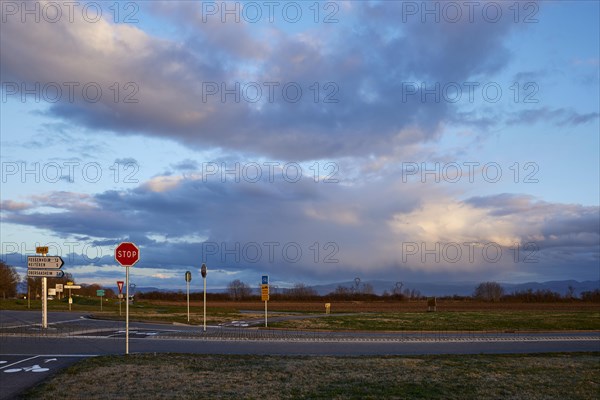 Weather change with mighty light to grey-blue clouds illuminated by the evening sun over the Black Forest as seen from Algolsheim, Haut-Rhin, Grand Est, France, Europe