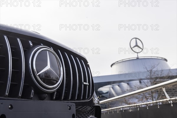Mercedes, radiator grille and Mercedes star on a modern vehicle, in the background the Mercedes Benz World, customer centre and car dealership in Bad Cannstatt, Baden-Wuerttemberg, Germany, Europe