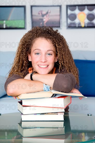 Pupil leaning on a pile of books