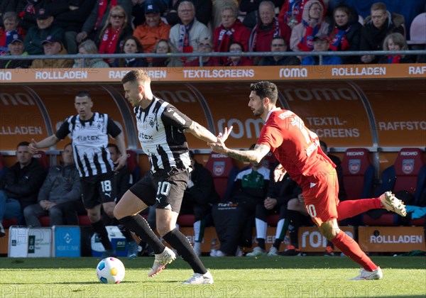 Football match, Tim KLEINDIENST 1.FC Heidenheim right fighting for the ball with Nico ELVEDI Borussia Moenchengladbach left in the background Stefan LAINER Borussia Moenchengladbach, football stadium Voith-Arena, Heidenheim