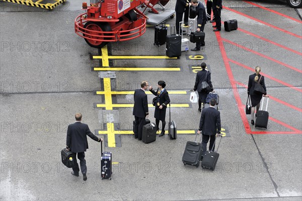 Crew members with wheeled suitcases walking down an aeroplane staircase, Hamburg, Hanseatic City of Hamburg, Germany, Europe